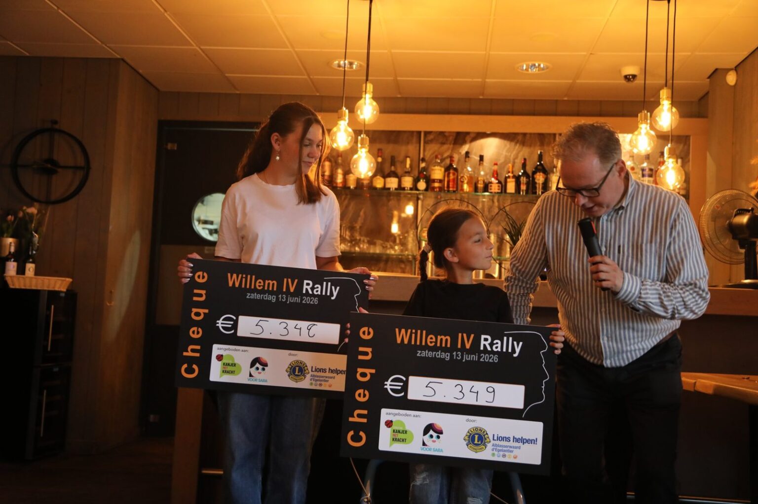 Uitreiking van de twee cheques van elk 5.349 euro aan de goede doelen tijdens het diner
